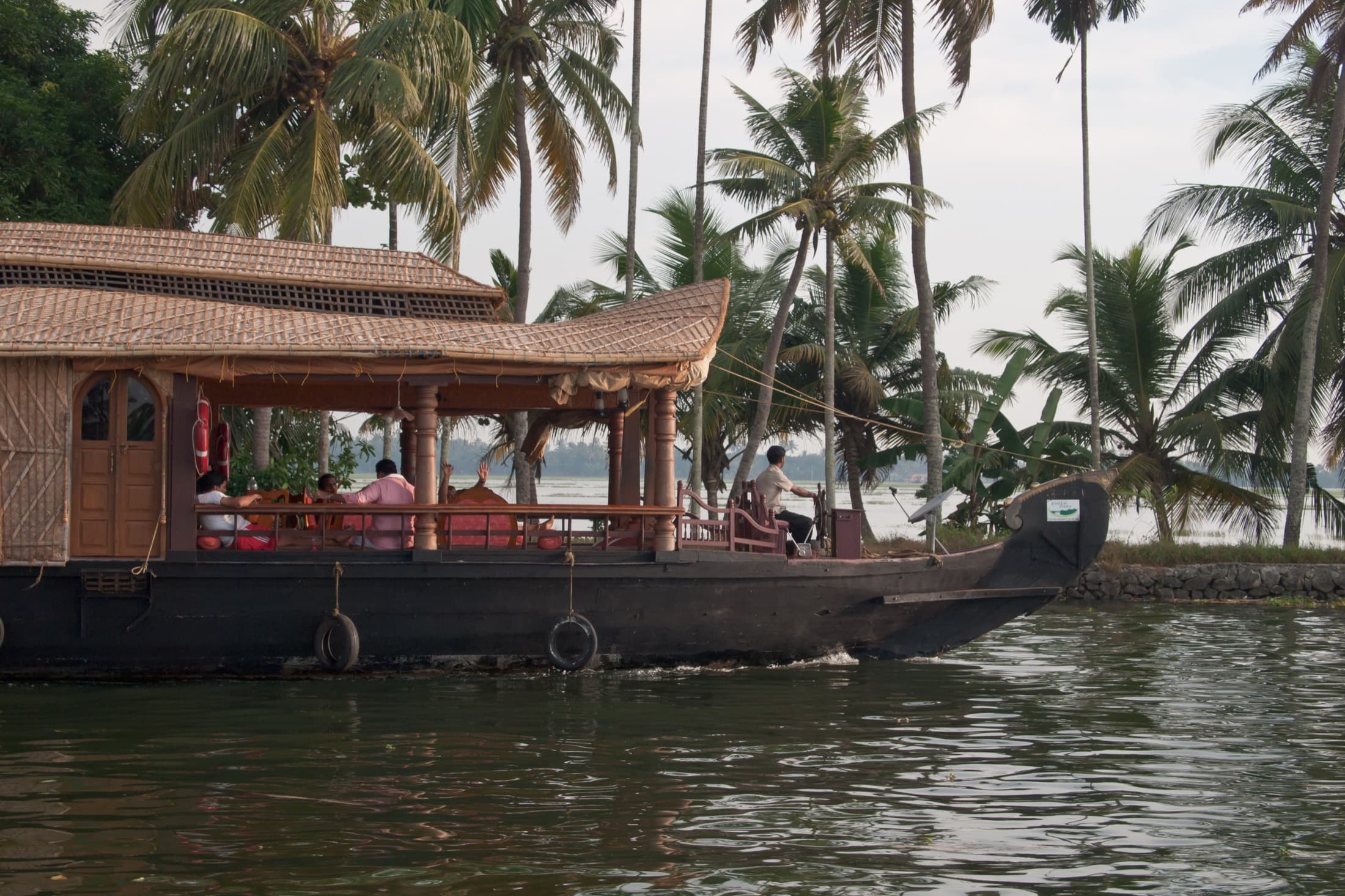 Kerala houseboat cruise framed by tropical water and palms